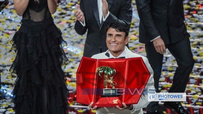 Saul Da Vinci sul palco dell'Ariston mostra sorridente il premio per la Vittoria al Festival di Sanremo 2026